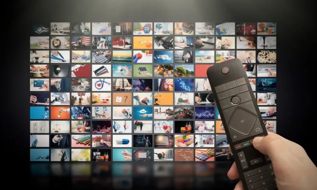 A man streaming movies on the TV in boredom