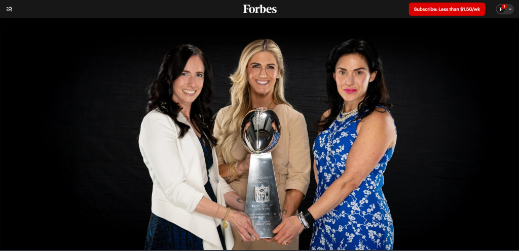 Carlie Irsay Gordon holding trophy with other two womens