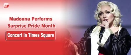 Madonna with platinum blonde hair performing with a microphone on a Pride concert banner for stuffablog.com.